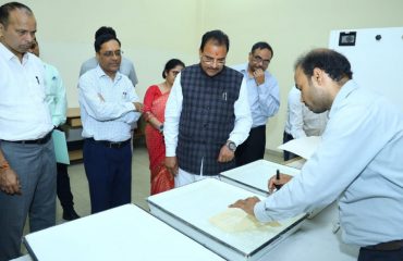 Shri Ajay Bhatt, Hon'ble Raksha Rajya Mantri visiting De-acidification & Fumigation Room at AU&RC, RSB Complex