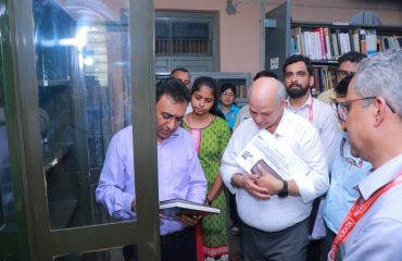 Sri Rajesh Aggarwal, IAS, Secretary, Department of Empowerment of Persons with Disabilities (Divyangjan), Ministry of Social Justice and Empowerment, Govt. of India reading thesis work of students at Library of NILD.