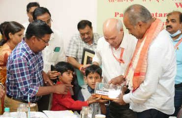 Sri P. C. Mohan, Chairman, Parliamentary Standing Committee on Social Justice and Empowerment receiving memento by Divyang child
