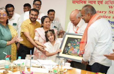 Sri P. C. Mohan Chairman, Parliamentary Standing Committee on Social Justice and Empowerment receiving memento by Divyang child
