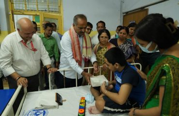 Sri P. C. Mohan delivering fruits packet to indoor patient during the visit