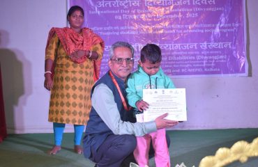 Dr. Ameed Equebal, Asstt. Director (Training) awarding the certificate and prize to Divyang child