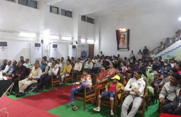 Audience members enjoying the magic show with great enthusiasm and delight.