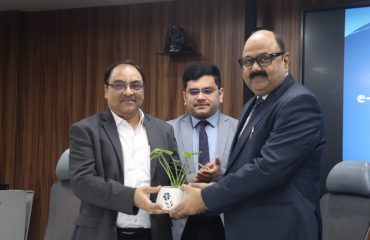 Dr. Ashok Kumar Hota, DDG & SIO, NIC Odisha presenting sapling to Shri Bidyut Kumar Mishra, Director, Odisha Judicial Academy.