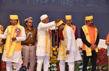 His Excellency presenting medals to toppers