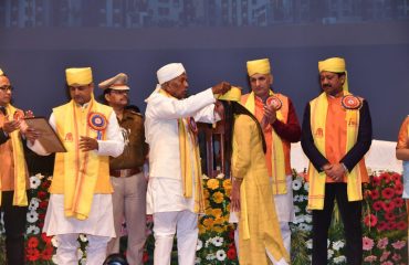 His Excellency presenting medals to toppers.