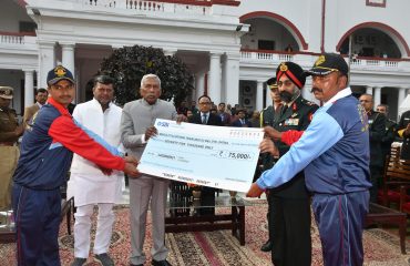 His Excellency presenting a cheque to Cyclothon team.