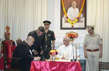 Honorable The Chief Justice signing the oath document.