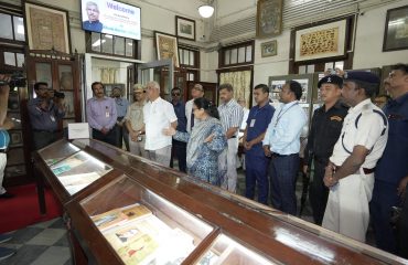 His Excellency observing the library.