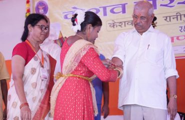Volunteers tying rakhi to His Excellency.