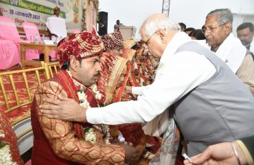 Honorable Governor meeting the newly wed couples.
