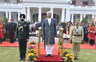 Honorable Governor in attention position for the National Anthem.