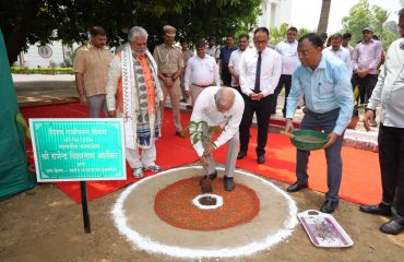 Honorable Governor pouring water to the plant.
