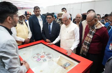 Honorable Governor observing different postage stamps at the exhibition.