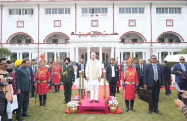 Honorable Governor in attention position for the National Anthem.