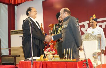 Honorable Chief Justice congratulating Honorable Governor after administering the oath.