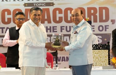 Hon'ble Governor felicitating T.C.A. Raghavan at the event.