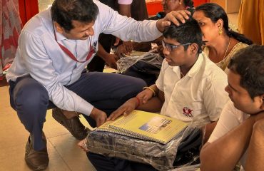 Distribution of Uniform, Books and bag to one of the beneficiary