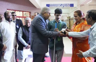 Hon'ble Vice President of India Shri.Jagdeep Dhankhar, distributing Aids and Assistive devices to one of the beneficiary