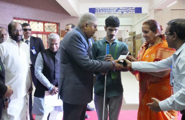 Hon'ble Vice President of India Shri.Jagdeep Dhankhar, distributing Aids and Assistive devices to one of the beneficiary