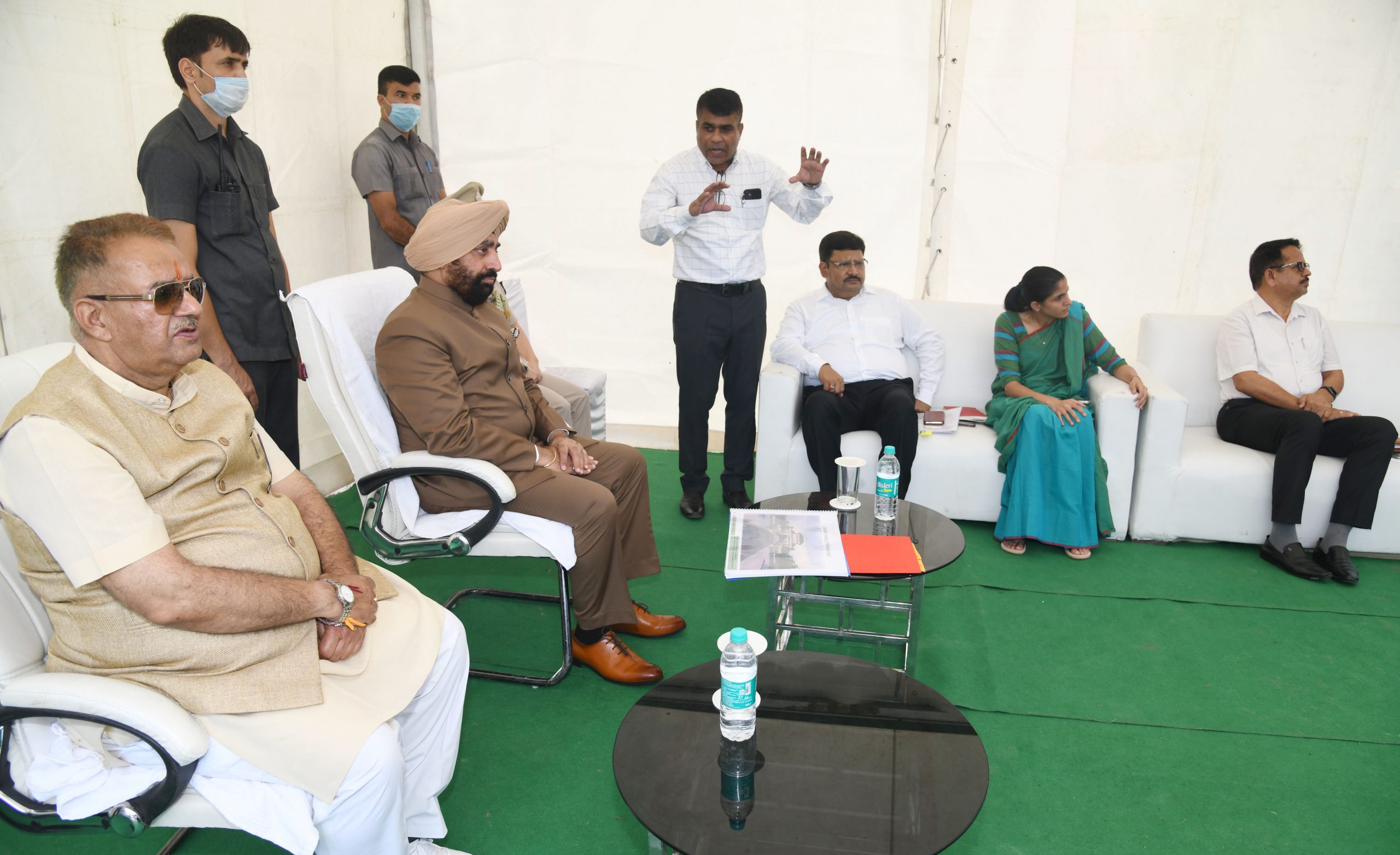 23-08-2022 : Governor receiving information from the officials regarding the under construction Sanya Dham at Guniyalgaon.
