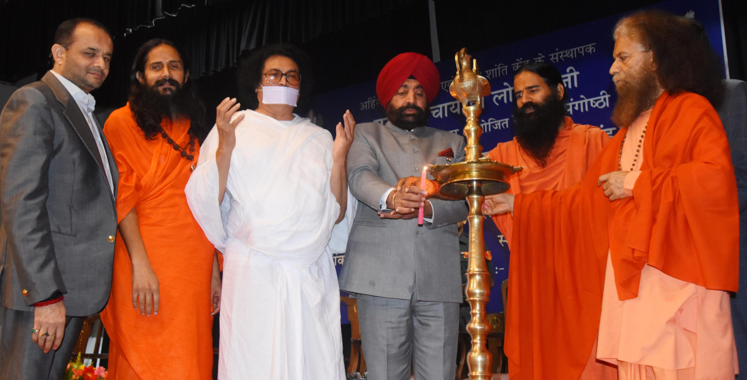 Governor lighting the lamp of the national seminar program organized by Ahinsa Visva Bharati on the theme