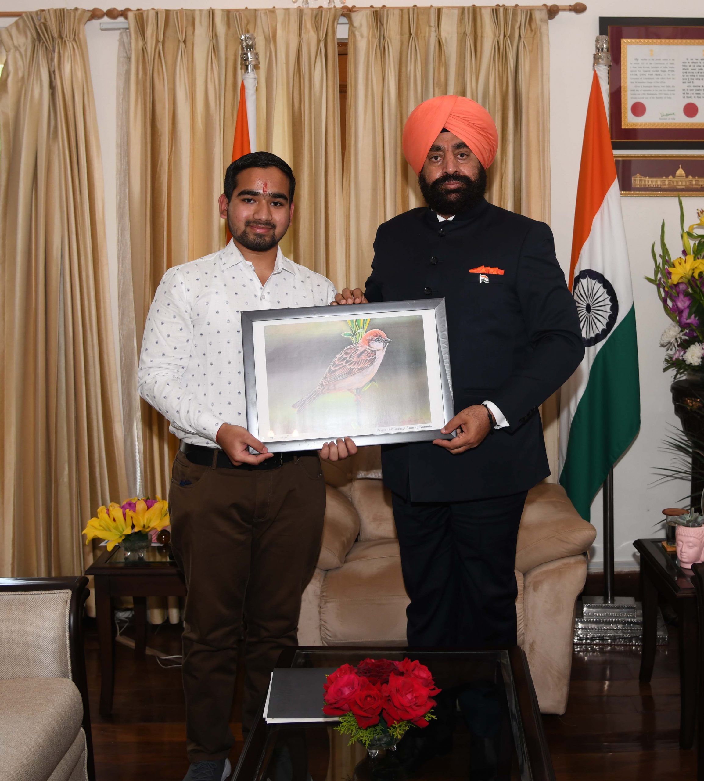 Anurag Ramola presenting a painting of Gauraiya to Governor.