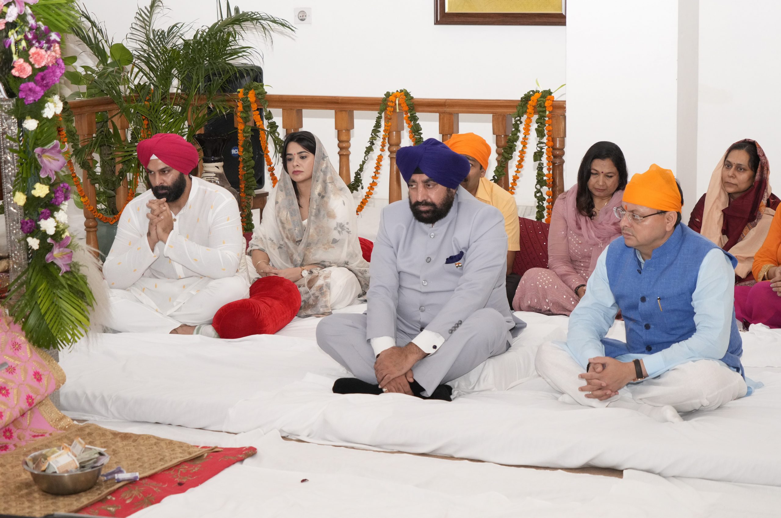 Governor Lt Gen Gurmit Singh (Retd) and Chief Minister Pushkar Singh Dhami listen to the recitation of the holy Sri Guru Granth Sahib.