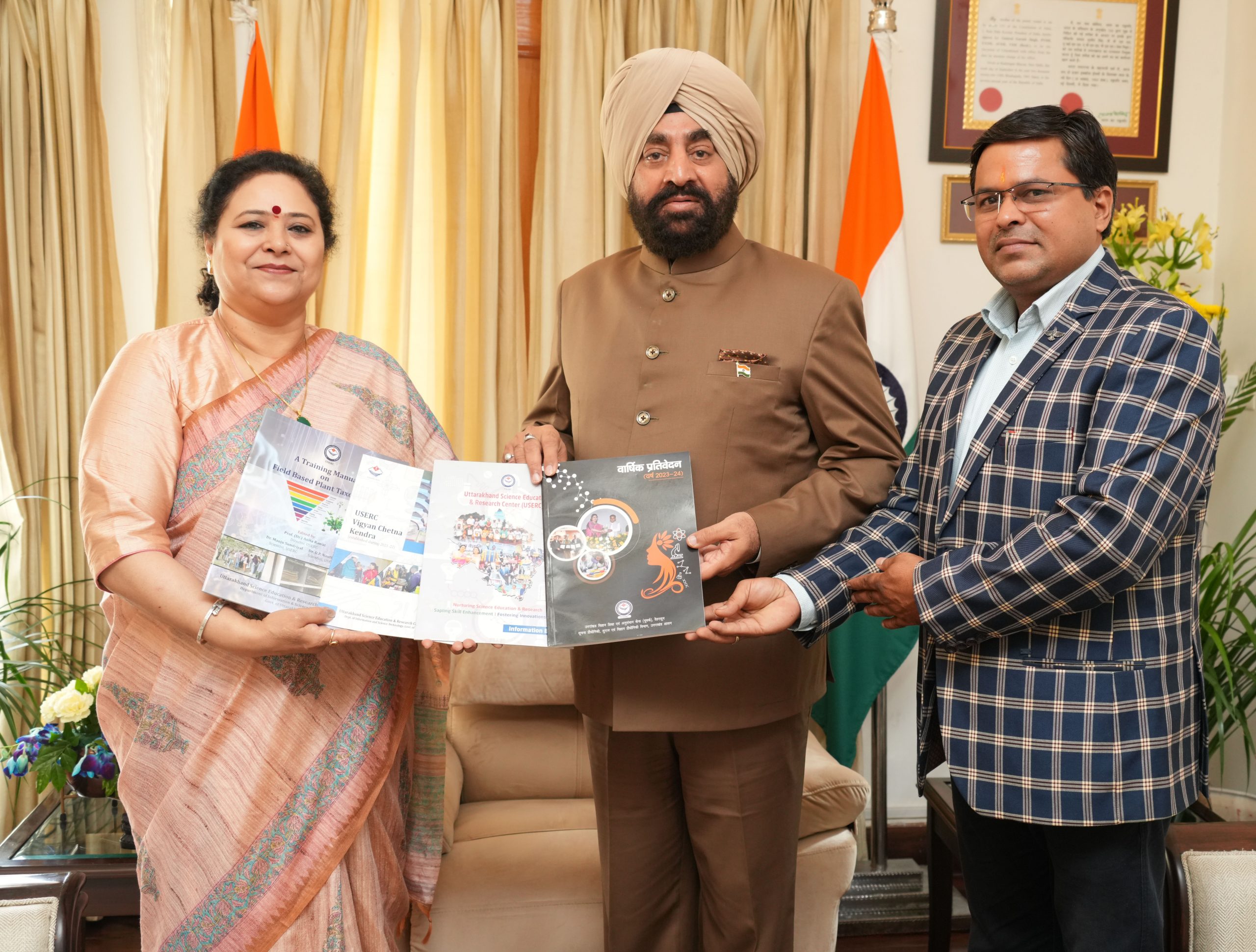USERC Director Prof. Anita Rawat and scientist Dr. O.P. Nautiyal meeting and presenting the annual report to the Governor.