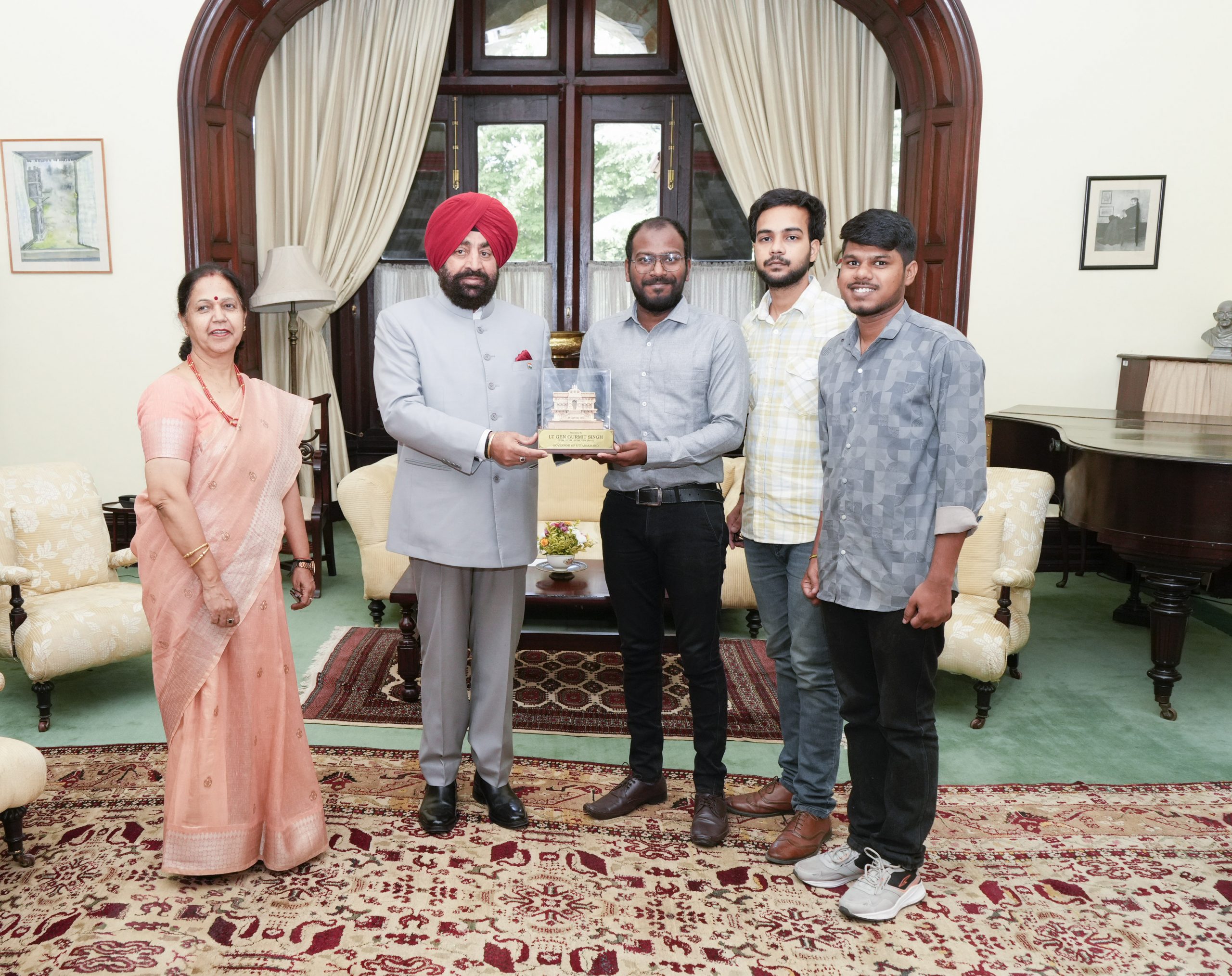Hon'ble Governor presenting a momento of Shri Badri Vishal to students on the occasion of Telangana State Formation Day.