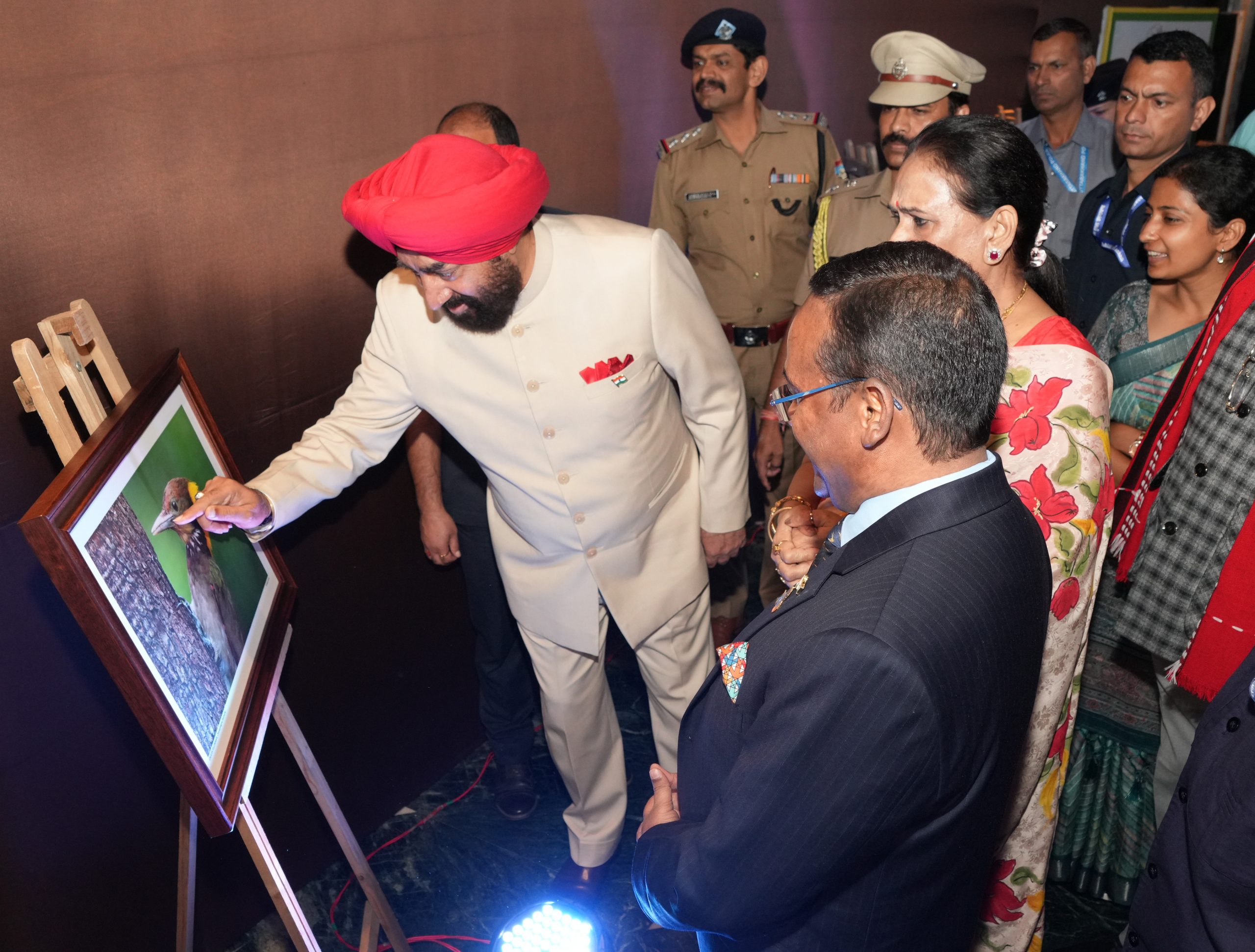 Governor admiring the photographs of birds at an event organized in Mussoorie.