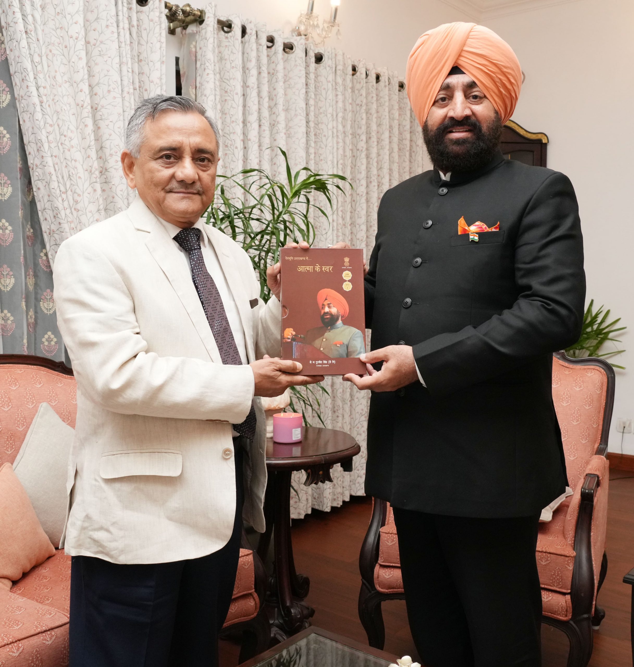 Governor presenting his book "Atma Ke Swar" to CDS General Anil Chauhan.