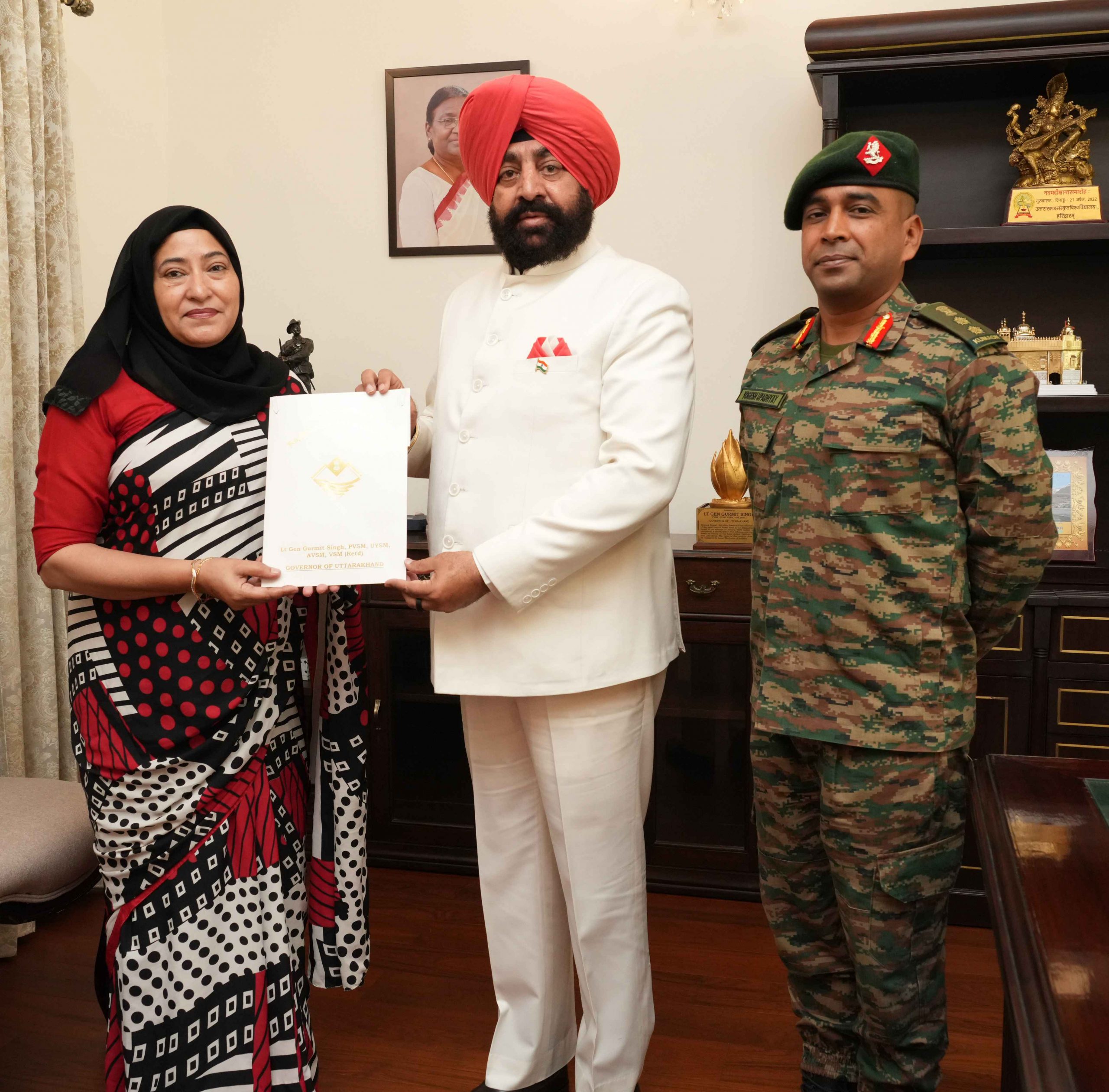The Governor being apprised by the Vice President of the Management Committee of 'Golden Ki Asha School' Colonel Yogesh Upadhyay and Principal Samra Mirza.