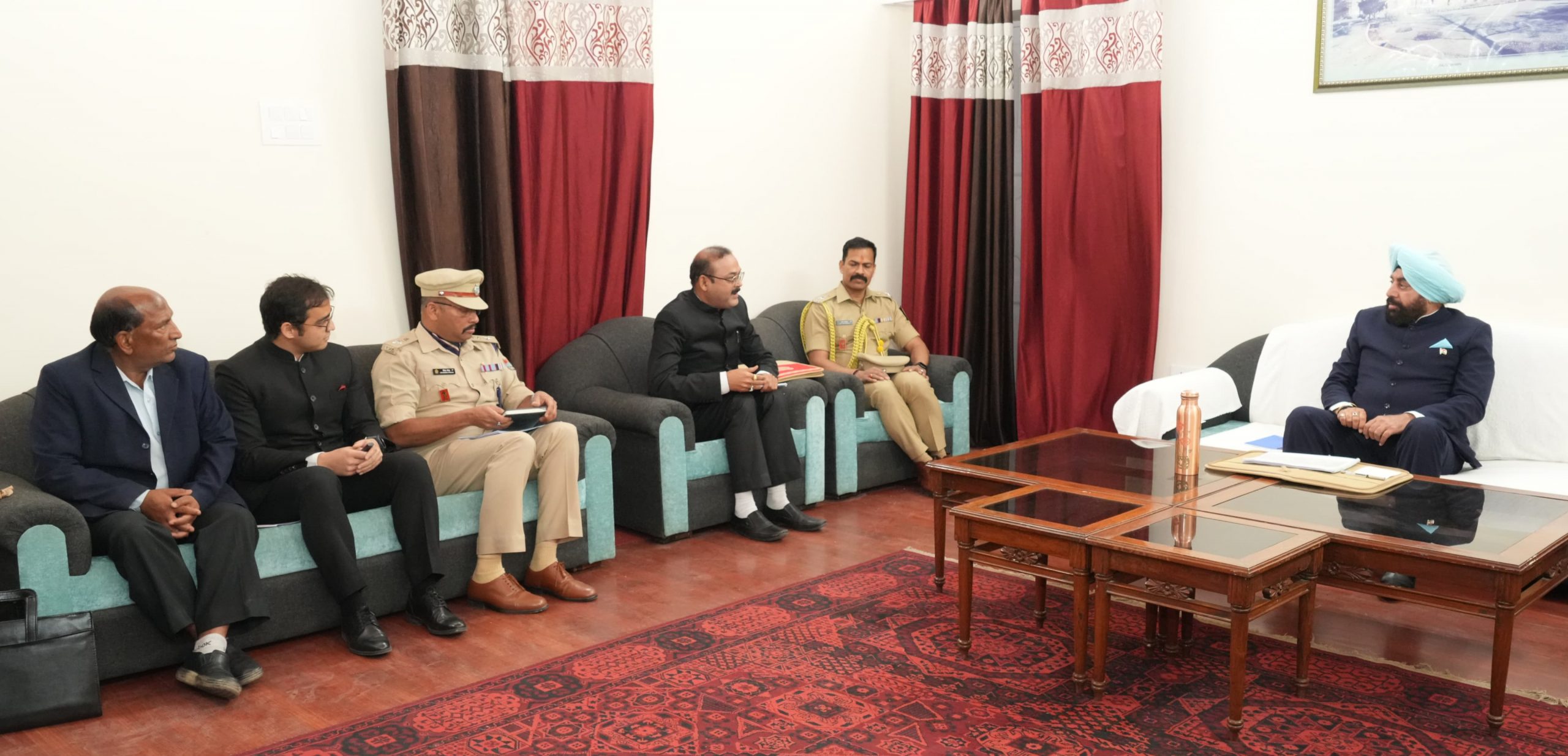 Governor holding a meeting with senior officials of the district administration at the Circuit House in Almora.