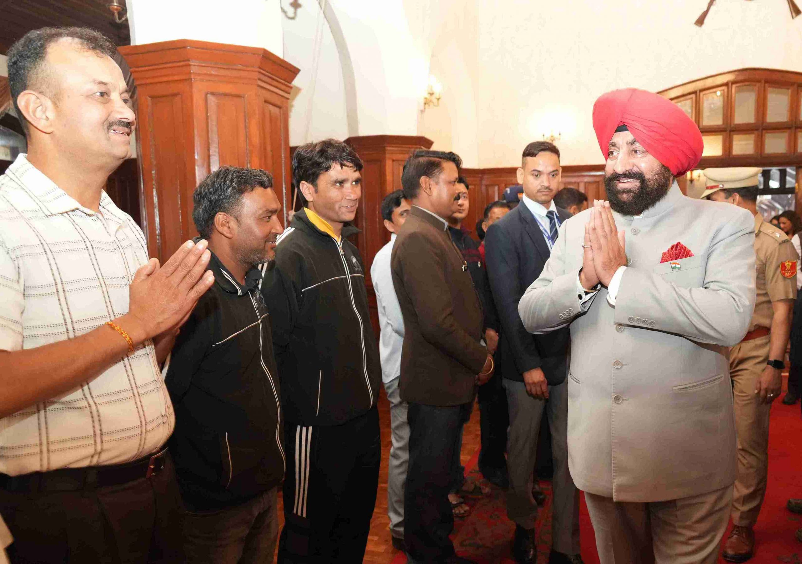 Governor meeting personnel and their families in the Parivar Milan program organized at Raj Bhawan Nainital.