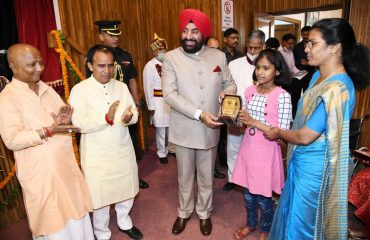 Governor Lt Gen Gurmeet Singh (R) felicitating the winning participant of the National Painting Competition, at Raj Bhawan