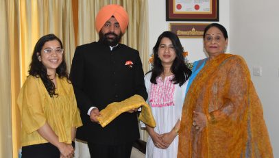 Alisha and Ankita Mandolia of 'Mulya' Association presenting a floral printed turban to Governor Lt Gen Gurmit Singh (Retd).
