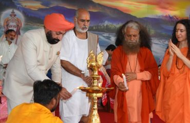 Governor inaugurating the program organized on the occasion of 70th birth anniversary celebrations of Pujya Swami Chidanand Saraswati Ji Maharaj at Parmarth Niketan by lighting the lamp.