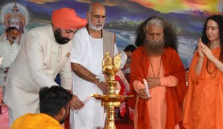 Governor inaugurating the program organized on the occasion of 70th birth anniversary celebrations of Pujya Swami Chidanand Saraswati Ji Maharaj at Parmarth Niketan by lighting the lamp.