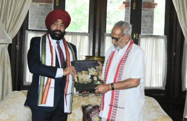 Governor presenting a book based on Raj Bhavan Nainital to The Governor of Odisha, Prof. Ganeshi Lal.
