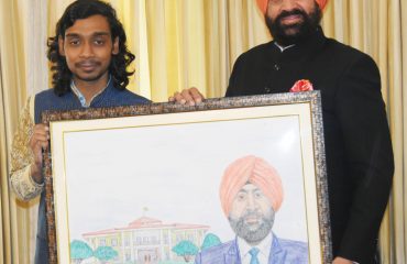 Apoorva Om, a young artist with hearing impairment, presenting his painting to Governor Lt Gen Gurmit Singh (Retd).