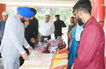 Governor Lt Gen Gurmit Singh (Retd) receiving information about the exhibition of Bedu's products from Pithoragarh District Administration and Self Help Groups.