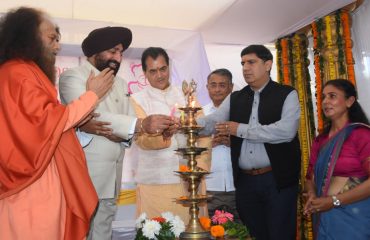 Governor inaugurating the Sri Sathya Sai Sanjeevani Hospital by lighting the lamp at Raiwala.