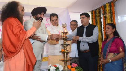 Governor inaugurating the Sri Sathya Sai Sanjeevani Hospital by lighting the lamp at Raiwala.