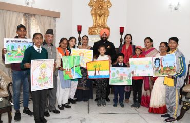 Governor giving prizes to the children who won the state level in the painting competition.