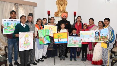 Governor giving prizes to the children who won the state level in the painting competition.