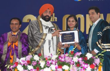 Governor presenting a citation to a student at the 20th convocation ceremony organized at the University of Petroleum and Energy Studies (UPES), Vidhauli.