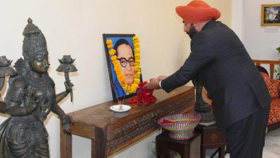 Governor paying tribute by offering flowers on the portrait of Bharat Ratna Babasaheb Dr. Bhimrao Ambedkar.