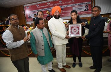 Governor felicitating Ms. Kavya Bohra, a visually impaired Divyang, who secured the highest marks in M.Ed (Special Education).