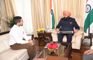 Anurag Ramola presenting a painting of Gauraiya to Governor.